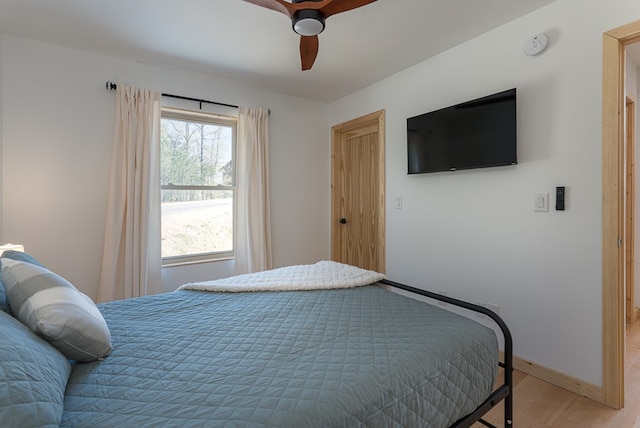 bedroom with hardwood / wood-style floors and ceiling fan