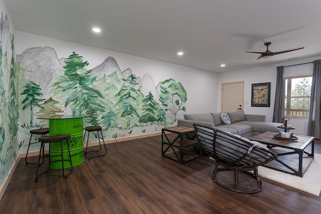 living room featuring dark wood-type flooring and ceiling fan