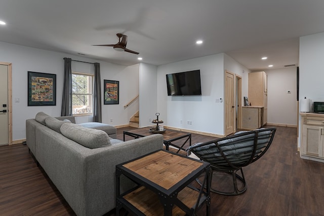 living room featuring dark wood-type flooring and ceiling fan