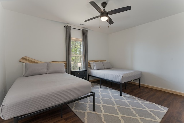 bedroom featuring dark hardwood / wood-style floors and ceiling fan