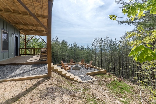 view of yard featuring a fire pit and a wooden deck