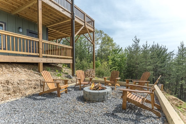 view of patio / terrace with a fire pit and a wooden deck