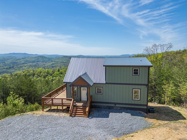 view of front of house with a deck with mountain view