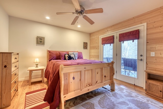 bedroom featuring ceiling fan, wooden walls, recessed lighting, access to outside, and light wood finished floors