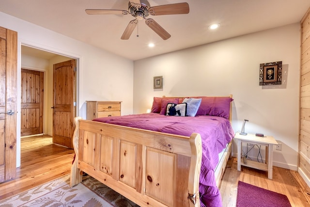 bedroom featuring ceiling fan, baseboards, wood finished floors, and recessed lighting