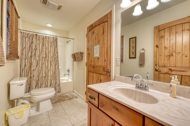 full bathroom featuring toilet, vanity, visible vents, tile patterned floors, and shower / bath combo