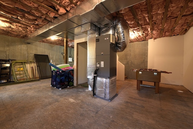 unfinished basement featuring heating unit