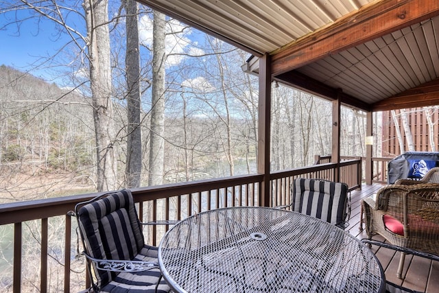 wooden terrace with outdoor dining area