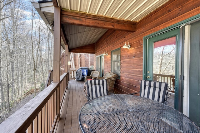 wooden deck featuring outdoor dining space