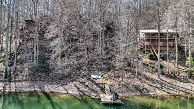 birds eye view of property with a forest view and a water view