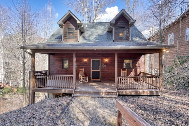 rustic home featuring roof with shingles