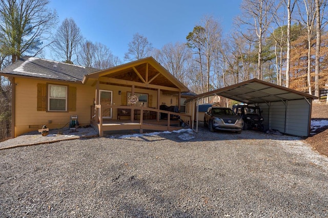 view of front of home with crawl space, a carport, gravel driveway, and a shingled roof