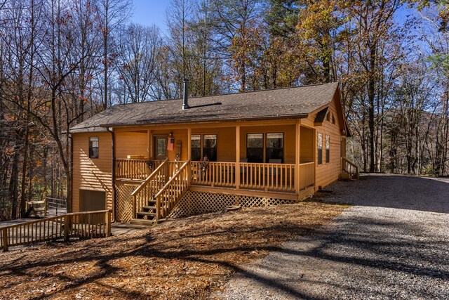 view of front of property featuring covered porch and a garage