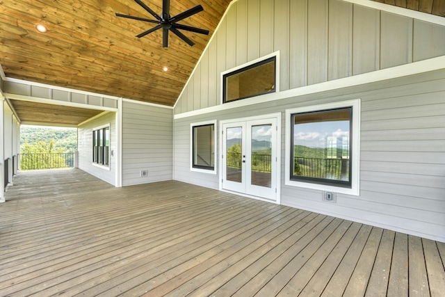 wooden terrace with a ceiling fan and french doors