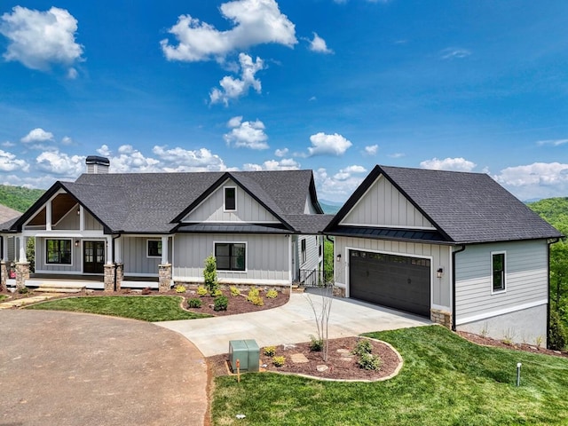 modern farmhouse style home featuring roof with shingles, concrete driveway, a front lawn, and board and batten siding