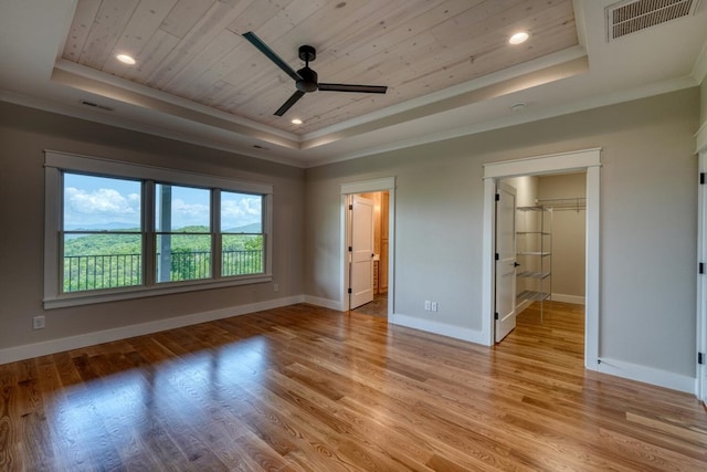 unfurnished bedroom featuring a tray ceiling, crown molding, wooden ceiling, and visible vents
