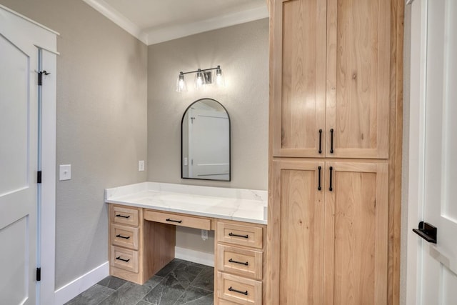 bathroom featuring crown molding, baseboards, and vanity