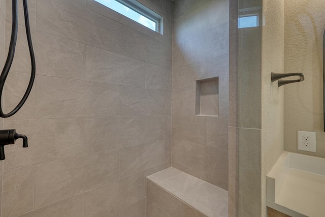 bathroom featuring tiled shower