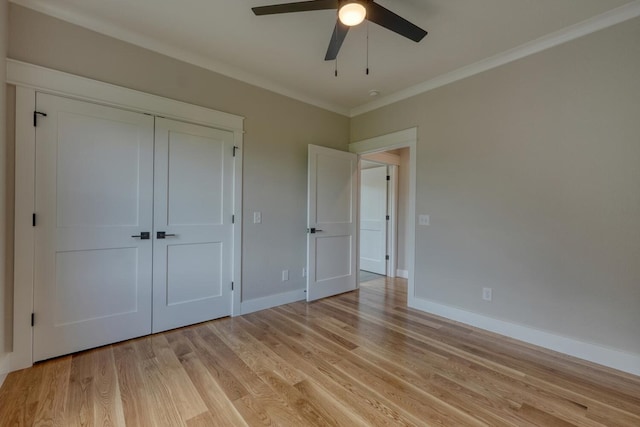 unfurnished bedroom with ornamental molding, light wood-style flooring, and baseboards