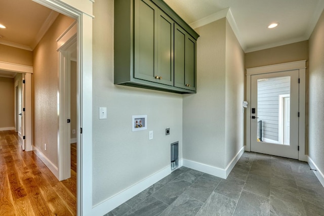 laundry area featuring electric dryer hookup, cabinet space, hookup for a washing machine, crown molding, and baseboards
