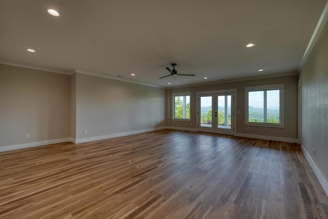 empty room featuring wood finished floors, crown molding, baseboards, ceiling fan, and recessed lighting