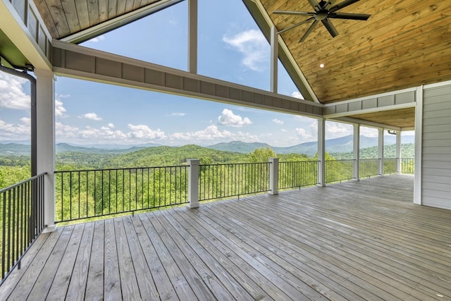 deck featuring a ceiling fan and a mountain view