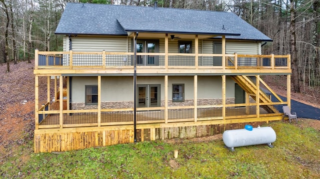 back of property featuring french doors, ceiling fan, and a wooden deck