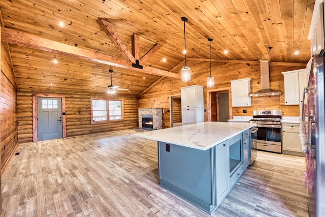 kitchen featuring white cabinetry, wall chimney exhaust hood, log walls, stainless steel appliances, and pendant lighting