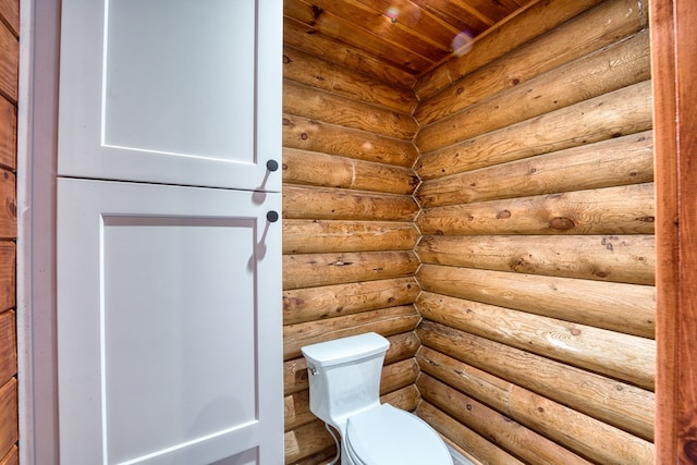 bathroom with rustic walls and toilet