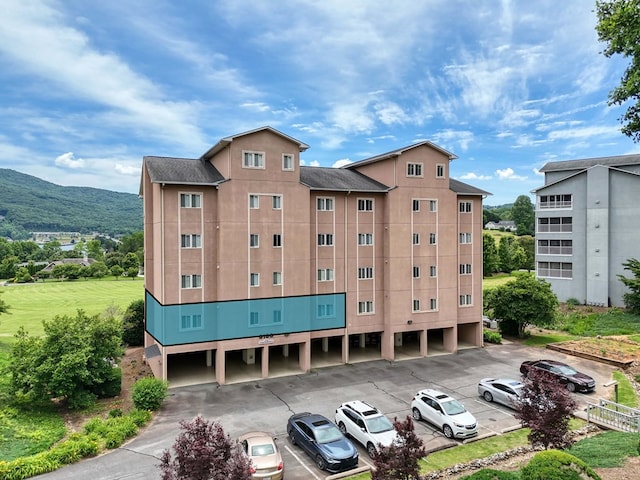 view of building exterior with a mountain view and a carport