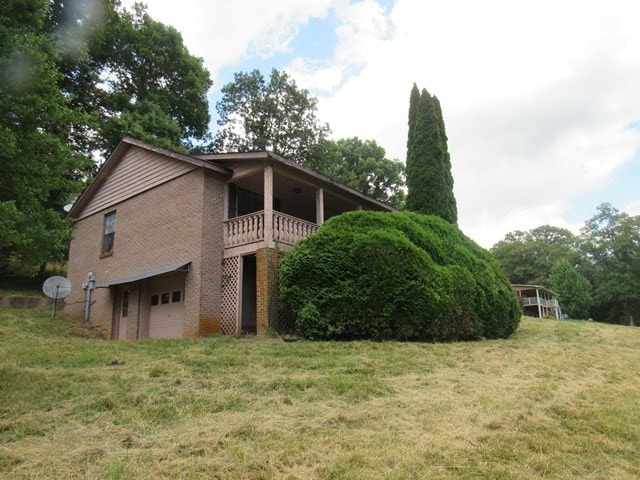 view of home's exterior featuring a yard and a garage