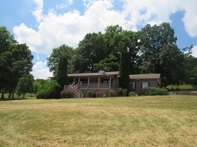 view of front of house with a front lawn and a porch