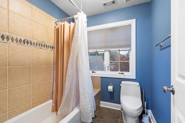 bathroom featuring tile patterned flooring, toilet, and shower / tub combo