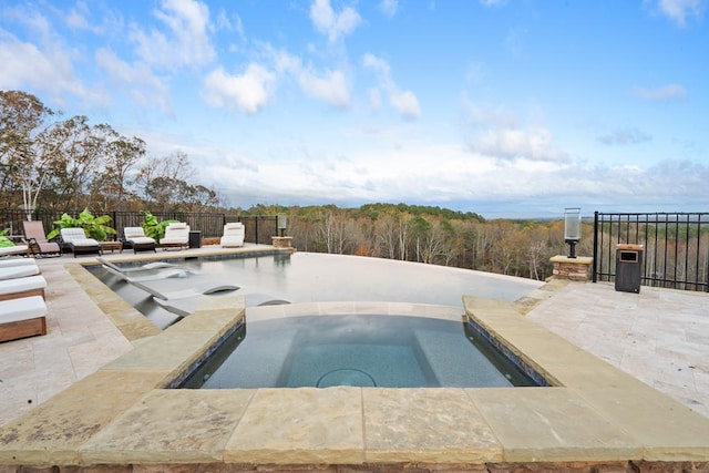 view of pool with a patio and an in ground hot tub