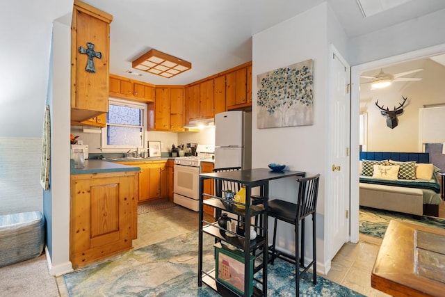 kitchen with white appliances, ceiling fan, sink, and light tile patterned flooring