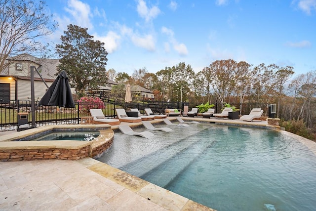 view of swimming pool with a patio and an in ground hot tub