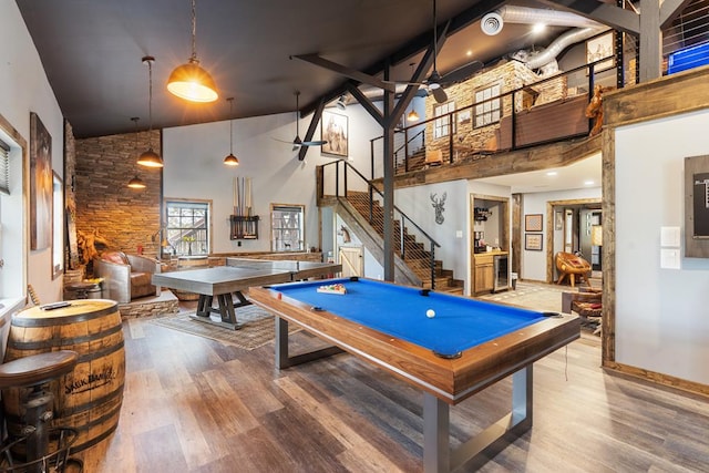 rec room featuring high vaulted ceiling, hardwood / wood-style floors, and billiards