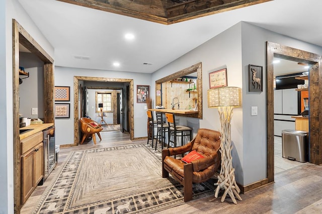 hallway with light hardwood / wood-style flooring and wine cooler