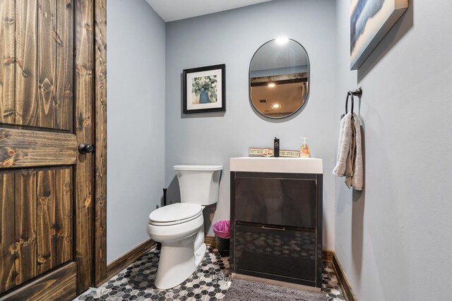 bathroom featuring toilet, vanity, and tile patterned floors