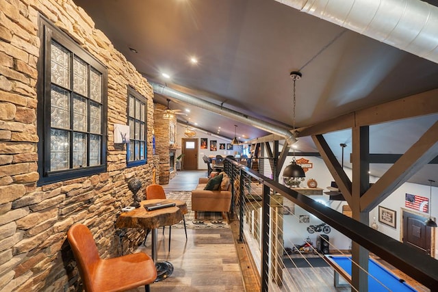 hall with hardwood / wood-style floors and lofted ceiling