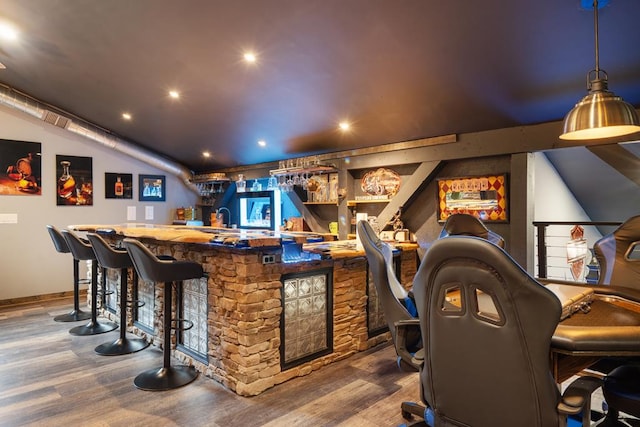 bar with hardwood / wood-style flooring