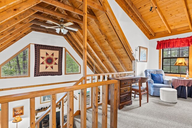 hall with carpet, vaulted ceiling with beams, and wooden ceiling