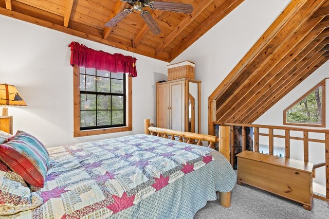 bedroom with carpet floors, wooden ceiling, ceiling fan, and vaulted ceiling with beams