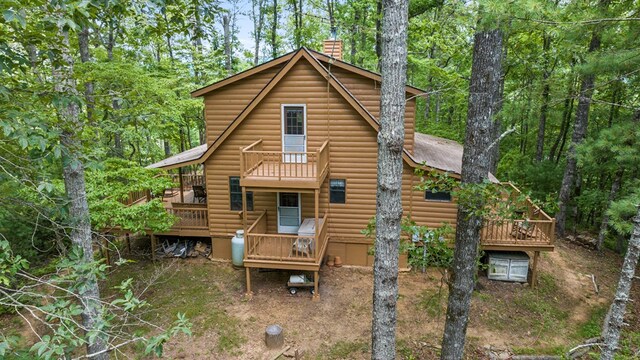 rear view of house with a wooden deck