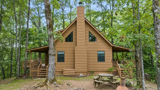 rear view of property featuring a deck