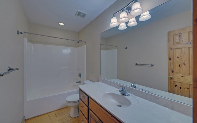 full bathroom with shower / bathtub combination, vanity, toilet, and wood-type flooring