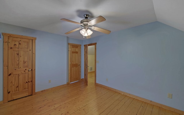 interior space with lofted ceiling, ceiling fan, and light wood-type flooring