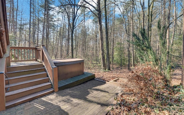 wooden deck with a hot tub