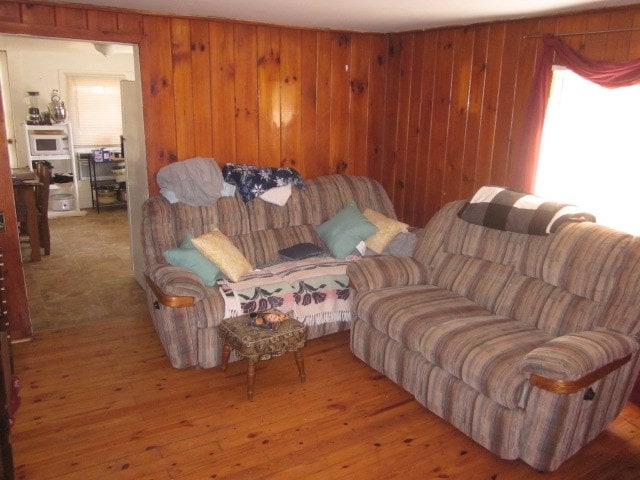 living room with wood walls and wood finished floors