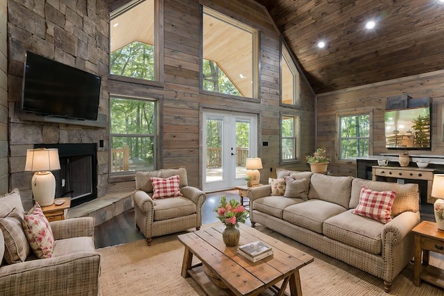 living room with high vaulted ceiling, a wealth of natural light, wooden walls, and wood ceiling